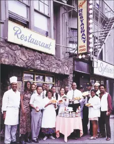  ?? From Carol M. Highsmith Archive, Prints and Photograph­s Division, Library of Congress. ?? Sylvia Woods and her employees outside the restaurant.