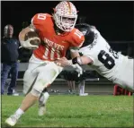  ?? CARLOS GUERRERO — DAILY DEMOCRAT ?? Mason Thomas breaks a tackle during the second half of the Wolves playoff game against Colfax.