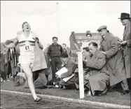  ?? Associated Press file photo ?? In this May 6, 1954 file photo, Britain’s Roger Bannister hits the tape in Oxford, England to become the first person to break the four-minute mile.