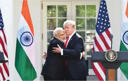  ??  ?? US President Donald Trump and Indian Prime Minister Narendra Modi embrace in the Rose Garden during a joint press conference at the White House in Washington on Monday. (AFP)