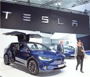  ?? AP ?? Tesla continuall­y offers over-the-air software updates to cars already sold.