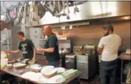  ?? CHARLES PRITCHARD - ONEIDA DAILY DISPATCH ?? James Egelston, left, Lonnie Gates, and Cody Logan work to get wings out to patrons at the Munnsville American Legion on Wednesday, Feb. 14, 2018.