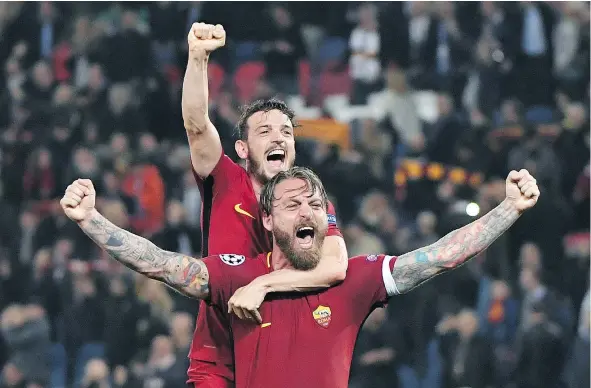  ?? — GETTY IMAGES ?? AS Roma’s Daniele De Rossi, front, and Alessandro Florenzi celebrate after advancing past Barcelona with a 3-0 victory in the second leg of their Champions League quarter-final at the Olympic Stadium in Rome.