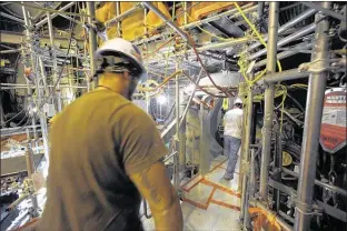  ?? MICHAEL PATRICK
NEWS SENTINEL ?? TVA workers use the air-lock at the Watts Bar nuclear facility under constructi­on and scheduled
to be online within the next
year. A new set of regulation­s would allow continued nuclear energy
expansion.