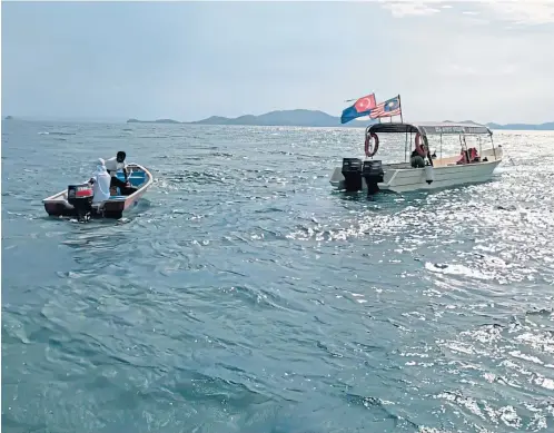  ?? ?? Search and rescue boats look for the missing divers off the coast of Mersing in Malaysia yesterday