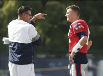  ??  ?? Tennessee Titans head coach Mike Vrabel talks with New England Patriots Tom Brady during a combined NFL football training camp on Wednesday in Nashville, Tenn. AP PhoTo/mArk humPhreY