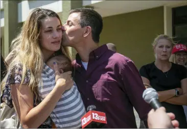  ?? DANIEL SHULAR — THE GRAND RAPIDS PRESS VIA AP ?? Michigan gubernator­ial candidate Ryan Kelly kisses his wife Tabitha Kelly after leaving the U.S. District Court in Grand Rapids with his family and supporters on Thursday, June 9. Kelley has been charged with four misdemeano­rs from his involvemen­t with the riot at the Capitol Building in Washington, D.C., on Jan. 6, 2021.