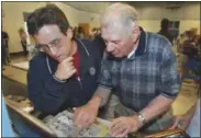  ?? THE ASSOCIATED PRESS ?? In this May 31, 2003, file photo, screenwrit­er Angelo Pizzo, left, looks at some old photos with former United States soccer player Frank Borghi at Shaw School during a casting call for the movie “The Game of Their Lives,” in St. Louis. Borghi, the...