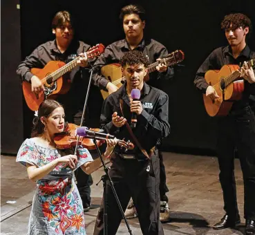  ?? REVIEW-JOURNAL/TNS CHITOSE SUZUKI/LAS VEGAS ?? Kevin A Aparicio Cabrera, center, sings as other members of the Las Vegas Academy of the Arts Mariachi Nacional group perform during the Mariachi Spring Concert at Lowden Theater on March 8 in Las Vegas.