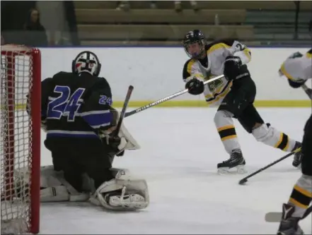  ?? TIM PHILLIS — FOR THE NEWS-HERALD ?? Amherst’s Jacob Kramer puts a shot on Midview goalie Braden Rapp on Feb. 10 at Brooklyn.