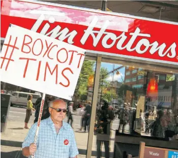  ?? GAVIN YOUNG/CALGARY HERALD ?? When Tim Hortons agreed to pull in-house advertisin­g featuring Enbridge’s Northern Gateway Pipeline project, a handful of Calgary protesters launched a counter-boycott which Emma Pullman of SumOfUs.org argues was ‘cooked up by Conservati­ve pundits.’