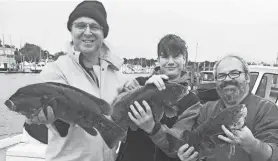  ?? PHOTOS COURTESY OF DAVE MONTI ?? Steve Burstein stands with Andrew Stevens and his father, Jim Stevens, of Warwick with fall tautog they caught at General Rock in North Kingstown on a trip last year.