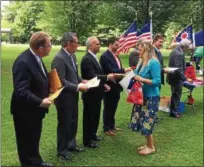  ?? CHAD FELTON — THE NEWS-HERALD ?? Newly sworn-in American citizen Katica Dreno is presented with commendati­ons from, right to left, Lake County Commission­er Jerry Cirino, Sen. John Eklund and state Rep. John Rogers at James A. Garfield Historic Site in Mentor on July 6.