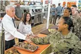  ?? ANDREW HARNIK/AP ?? Vice President Mike Pence, left, and his wife, Karen Pence, second from right, serve turkey for the Thanksgivi­ng holiday to troops on Saturday at Al Asad Air Base, Iraq.