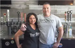  ?? MEG POTTER/THE REPUBLIC ?? Phillip and Gabriela Quintana pose for a portrait at their craft beer bar, Tap Savvy, in Litchfield Park on Jan. 1.