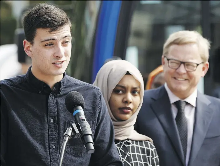  ?? IAN KUCERAK ?? Centre High student Blake Mueller, left, talks about the effect of reduced student transit fees at a news conference with Education Minister Daivd Eggen, right, at Churchill Square on Monday. Under the new program, eligible junior high and high school...