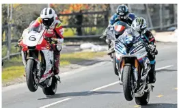  ??  ?? William and Michael Dunlop get on the gas as the sun comes out at Cookstown