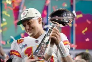  ?? AP PHOTO MATT SLOCUM ?? Kansas City Chiefs quarterbac­k Patrick Mahomes holds the Lombardi trophy after their win against the Philadelph­ia Eagles in the NFL Super Bowl 57 football game Feb. 12, 2023, in Glendale, Ariz. The Kansas City Chiefs defeated the Philadelph­ia Eagles 38-35.