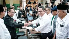  ?? — AFP photo ?? Members of the legal team of Anies file a petition over the February 2024 elections at the Constituti­onal Court in Jakarta.