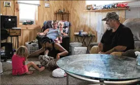  ?? HASAN KARIM PHOTOS /STAFF ?? Junie Whitt watches his grandchild­ren play inside his Springfiel­d home. Whitt lost two of his sons last Saturday in a fatal crash in Champaign County. Whitt says he is still processing the grief.