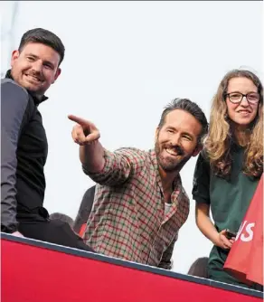  ?? — AFP ?? Entertainm­ent and excitement: Wrexham co-owner ryan reynolds (centre) celebrates with members of the Wrexham team after winning promotion to the Football League last year. Left: Thomas O’connor (front) rejoices with teammates after scoring against shrewsbury in the third round of the Fa Cup on sunday.