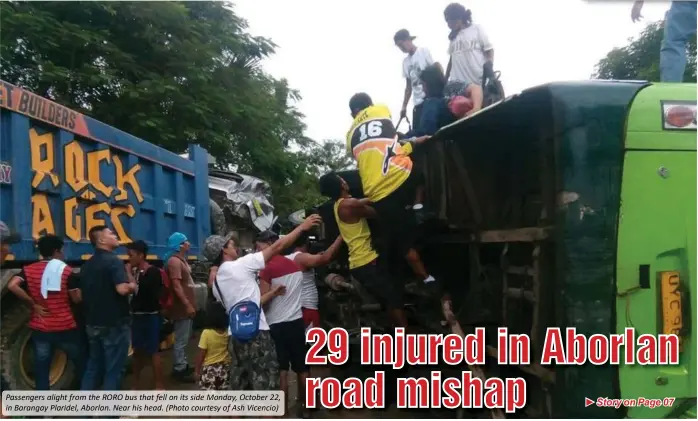  ?? (Photo courtesy of Ash Vicencio) ?? Passengers alight from the RORO bus that fell on its side Monday, October 22, in Barangay Plaridel, Aborlan. Near his head.