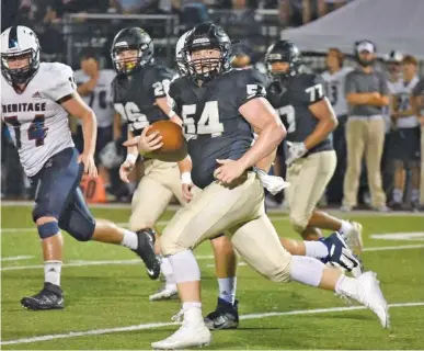  ?? STAFF PHOTO BY MATT HAMILTON ?? Christian Heritage senior middle linebacker Ben Williamson returns an intercepti­on during the Lions’ 39-7 home win against Catoosa County’s Heritage on Sept. 25 in Dalton, Ga. Williamson also plays on the offensive line and hopes his skills as a long snapper help him get noticed by a college football program.