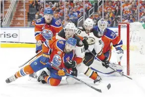  ?? CODIE MCLACHLAN/ GETTY IMAGES ?? The Oilers’ Kris Russell clashes with the Ducks.