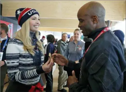  ?? ERIC GAILLARD — POOL PHOTO VIA AP ?? Ivanka Trump, daughter of U.S. President Donald Trump and senior White House adviser, gives a medal to former U.S. bobsledder Garrett Hines while visiting USA House during the 2018 Winter Olympics on Saturday in Pyeongchan­g, South Korea.