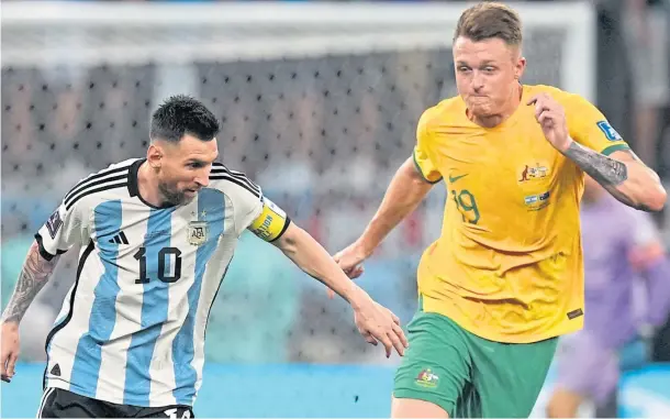  ?? ?? MAJOR CHALLENGE: The great Lionel Messi in a challenge with Harry Souttar, who neverthele­ss shone in Australia’s defeat to Argentina.