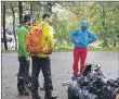  ??  ?? Some of the red burn team, top, and above, team members assess their rubbish haul.