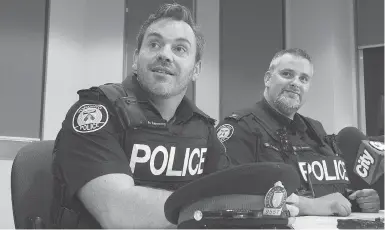  ?? STAN BEHAL/TORONTO SUN/POSTMEDIA NETWORK ?? Constables Josh Mcsweeney and Ryan Barnett swam through the flooded basement to rescue the trapped men.