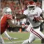  ?? PAUL VERNON — THE ASSOCIATED PRESS ?? Oklahoma running back Trey Sermon, right, stiff arms Ohio State cornerback Damon Arnette during the second half of an NCAA college football game Saturday in Columbus, Ohio. Oklahoma defeated Ohio State 31-16.