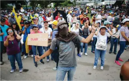  ??  ?? CARACAS: Anti-government demonstrat­ors protest in Caracas, Venezuela. Demonstrat­ors are taking the streets after three months of continued protests that has left dozens dead and seen the country’s chief prosecutor Luisa Ortega barred from leaving the...