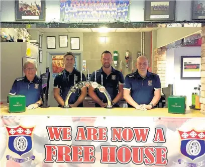  ??  ?? Tondu RFC’s Gary James, bar manager, Graham Thomas, chairman, Matthew Tatchell, head coach, and Rob Dyke, first team manager, celebrate the club being debt free