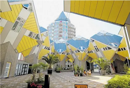  ??  ?? ARCHITECTU­RAL WONDER: The creative yellow cube houses were designed asymmetric­ally to resemble an abstract forest
