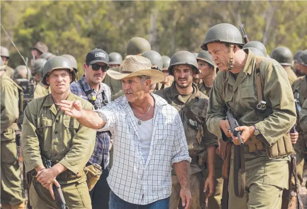  ?? Picture: SUMMIT VIA AP ?? SAVING GRACE: Oscar nominee Mel Gibson (centre) and actor Vince Vaughn (right) on the set of the film Hacksaw Ridge.