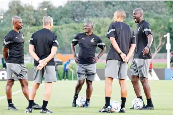  ?? — AFP photo ?? Otto Addo (right) shares a joke with his assistants during a training session at Aspire training zone in Doha on the eve of the Qatar 2022 World Cup football match between South Korea and Ghana.