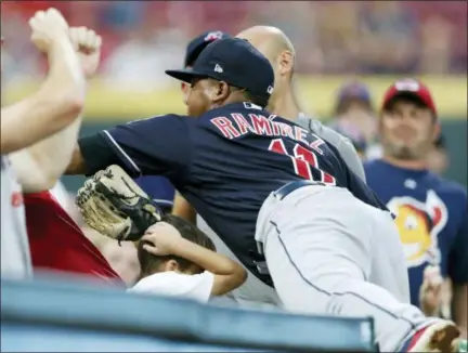  ?? GARY LANDERS — THE ASSOCIATED PRESS ?? A young fan ducks as Jose Ramirez attempts to catch a foul ball hit by the Reds’ Preston Tucker during the third inning Aug. 15 in Cincinnati. Tucker walked on the at-bat.