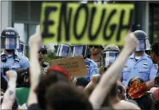  ?? MATT SLOCUM, FILE - THE ASSOCIATED PRESS ?? In this June 1file photo, protesters rally as Philadelph­ia Police officers and Pennsylvan­ia National Guard soldiers look on in Philadelph­ia, over the death of George Floyd, a black man who was in police custody in Minneapoli­s.