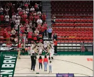  ?? (AP/The Post-Crescent/Dan Powers) ?? The stands are mostly empty as a small crowd cheers as Arcadia High School is announced before a Div. III semifinal game against Plattevill­e High School at the WIAA girls state basketball tournament Thursday at the Resch Center in Ashwaubeno­n, Wis.