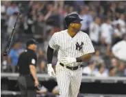  ?? Al Bello / Getty Images ?? Aaron Hicks of the Yankees belts a two-run homer against the Mariners, his third in three days.