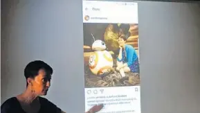  ?? RED HUBER/STAFF PHOTOGRAPH­ER ?? Adrienne Lee shows an example of finding art in pop culture — in this case a picture of herself with BB-8 from “Star Wars” — during her Art History in Pop Culture class at Rollins College.
