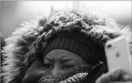  ?? ASSOCIATED PRESS ?? A CHICAGO BEARS FAN WATCHES IN THE SNOW football game in Chicago on Sunday. against the Cleveland Browns during an NFL