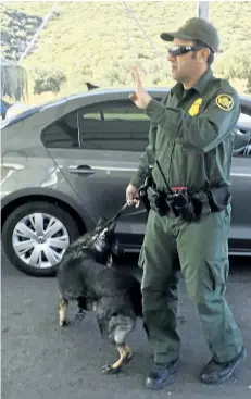  ?? ELLIOT SPAGAT/THE ASSOCIATED PRESS ?? In this Dec. 14 photo, a border patrol agent stops a vehicle at a checkpoint in Pine Valley, Calif. California legalizes marijuana for recreation­al use on Monday, Jan. 1, 2018, but that won’t stop federal agents from seizing small amounts on busy freeways and backcountr­y highways.