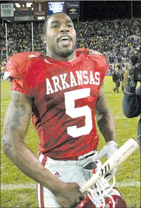  ?? Democrat-Gazette file photo ?? Arkansas running back Darren McFadden carried a team-issued miniature bat, with its “BRING THE WOOD” inscriptio­n, off the field after the Razorbacks’ three-overtime victory over top-ranked LSU at Baton Rouge in 2007. McFadden rushed for 206 yards and...