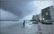  ?? VICTOR RUIZ GARCIA — THE ASSOCIATED PRESS ?? Clouds gather over Playa Gaviota Azul as Tropical Storm Zeta approaches Cancun, Mexico, Monday, Oct. 26, 2020. A strengthen­ing Tropical Storm Zeta is expected to become a hurricane Monday as it heads toward the eastern end of Mexico’s resort-dotted Yucatan Peninsula and then likely move on for a possible landfall on the central U.S. Gulf Coast at midweek.