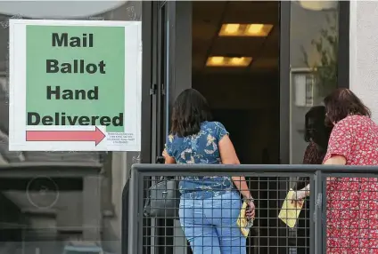  ?? Photos by Jerry Lara / Staff photograph­er ?? Voters hand-deliver mail-in ballots at the Bexar County Elections Department. Early voting in the Nov. 3 election runs from today through Oct. 30. About 400 to 600 ballots are being hand-delivered daily, county Elections Administra­tor Jacque Callanen said.