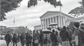  ?? J. SCOTT APPLEWHITE/AP ?? People gather on Capitol Hill as the Supreme Court begins its new term. A new stack of high-profile cases awaited the justices.