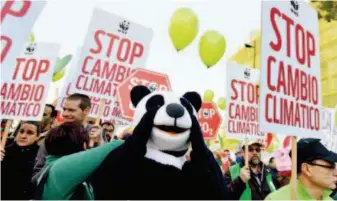  ??  ?? Protesters outside the venue of the United Nations Climate Change Conference in Madrid call for immediate action to combat climate change. Xinhua